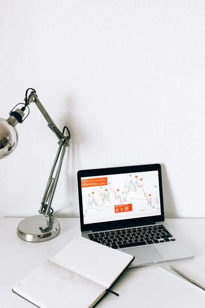A sleek workspace featuring a laptop displaying data analysis charts, perfect for business and technology themes.
